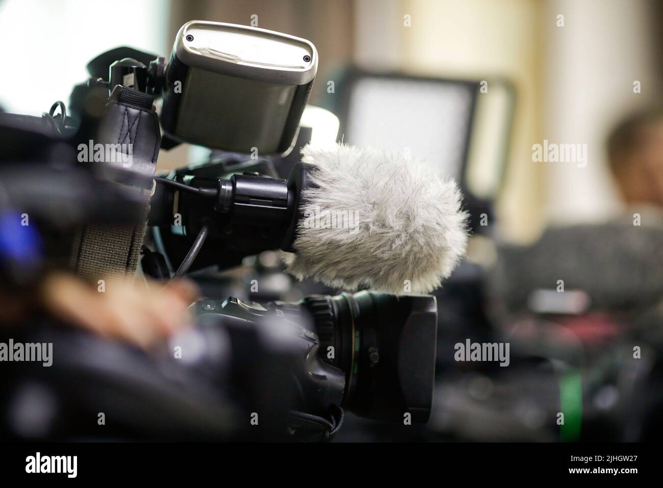 Shallow depth of field (selective focus) details with the microphones and lenses of news tv cameras during a press event Stock Photo