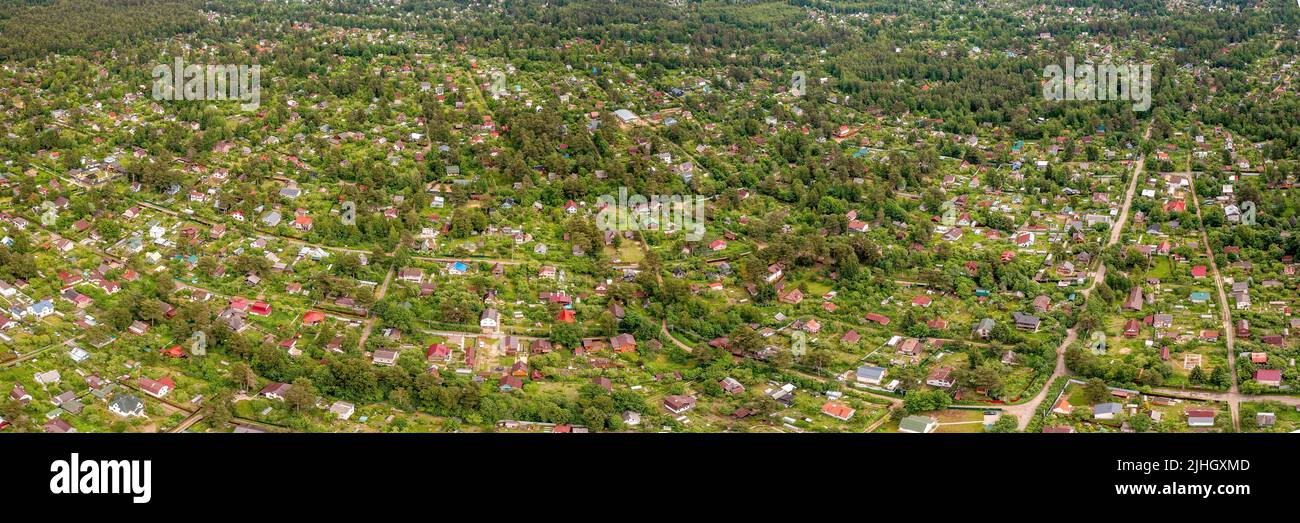 Country residential area with small houses large panoramic aerial view. Rural housing in the woodland from above Stock Photo