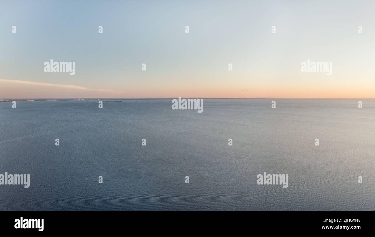 Horizon over sea sparse minimalist seascape. Calm blue sea and clear sky at sunset large panoramic  aerial view Stock Photo