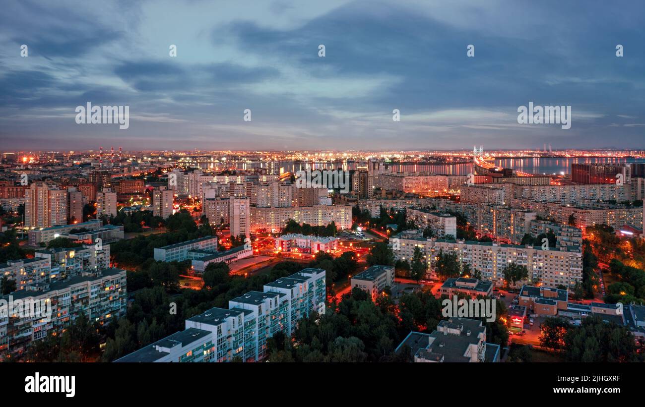 Generic illuminated residential district in large city at night aerial panoramic view. Saint Petersburg, Russia. Stock Photo