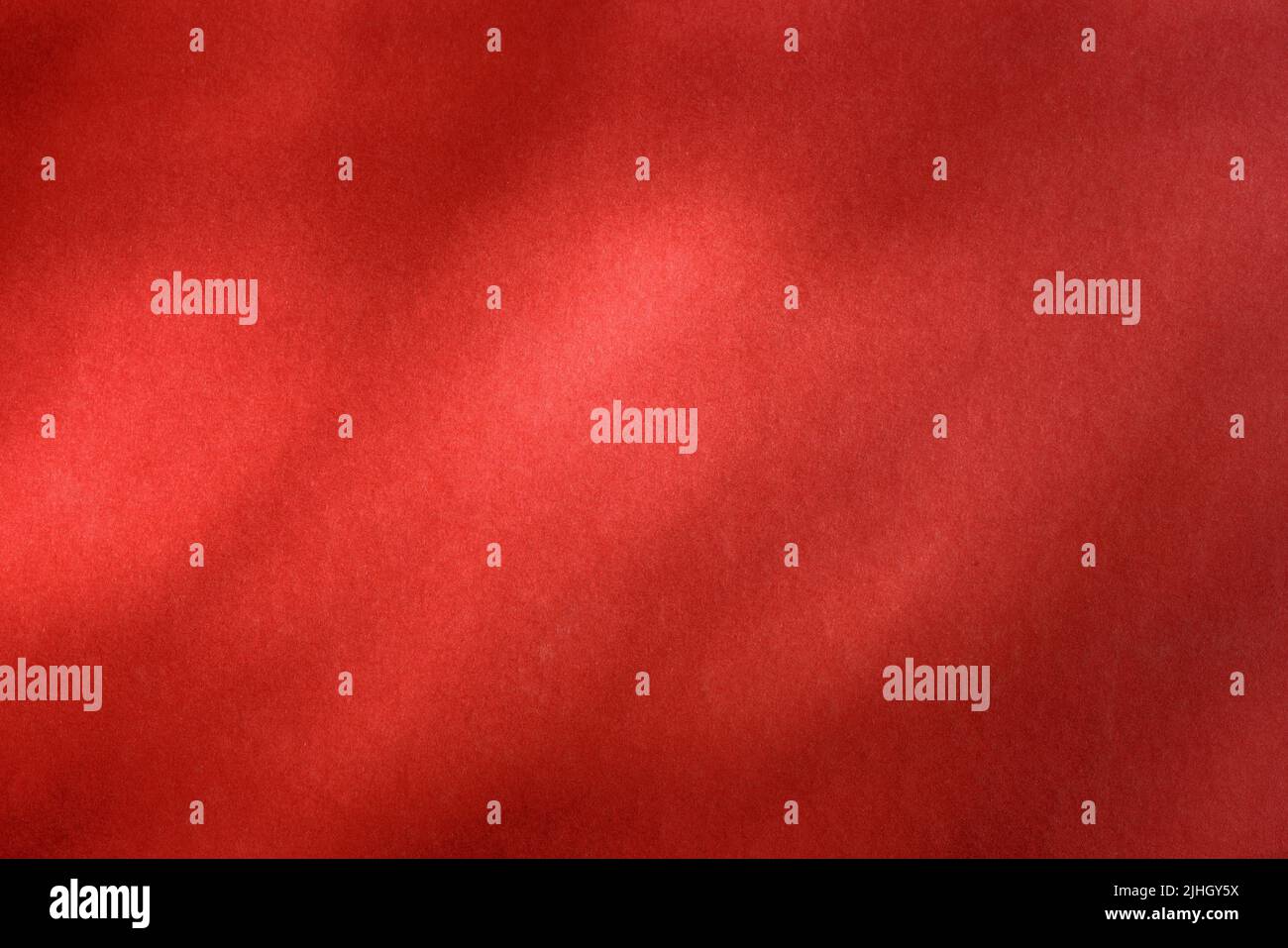 Empty red textured wall close up with shadows. Sparse texture and background Stock Photo