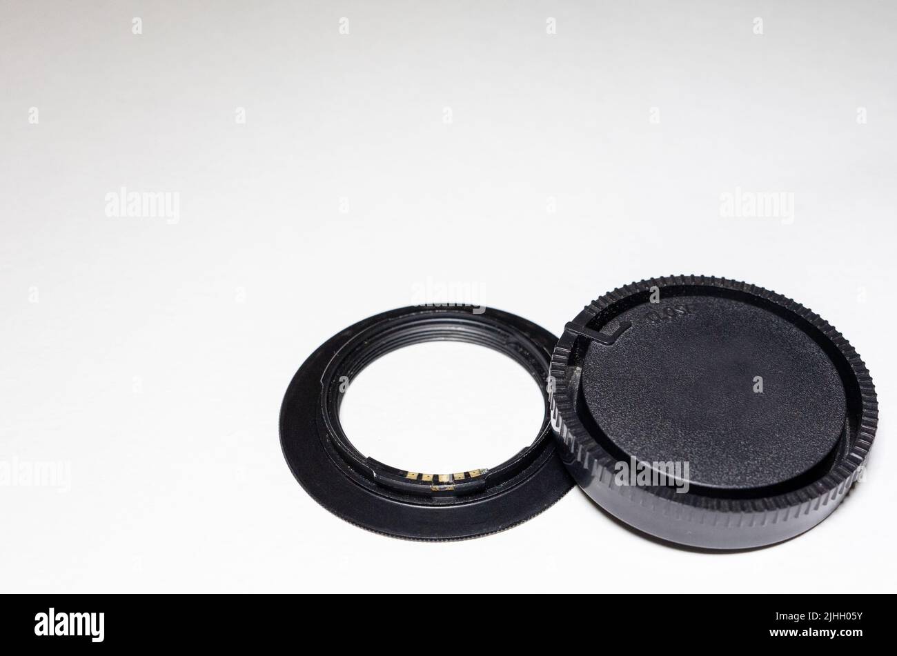 lens adapter and cap on a white background. Copy space. Stock Photo