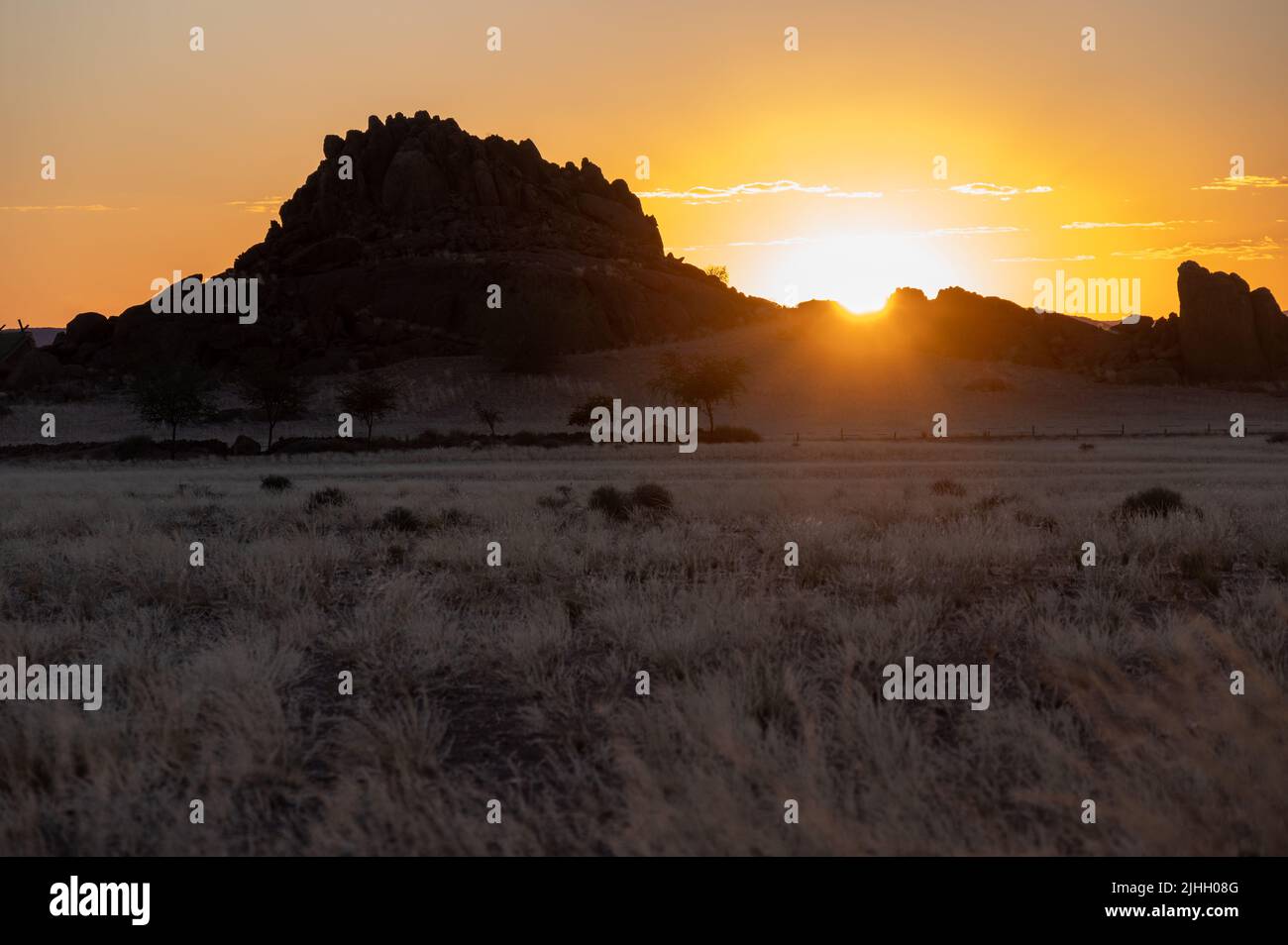 African sunset with mountains and grass plains Stock Photo