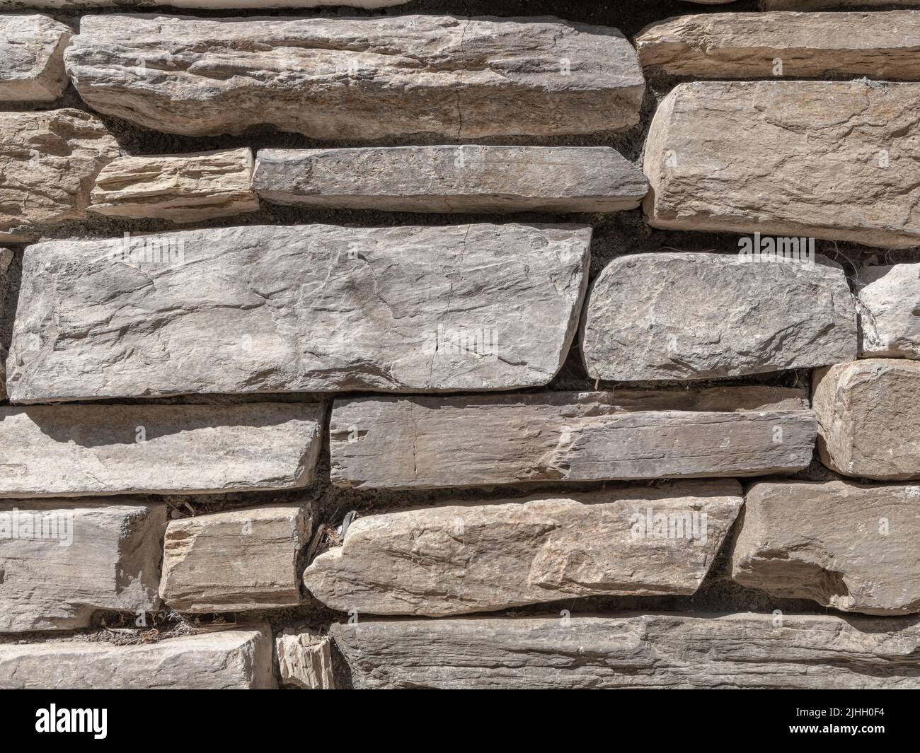 Medium close-up perspective of stacked and fitted exterior stone wall Stock Photo