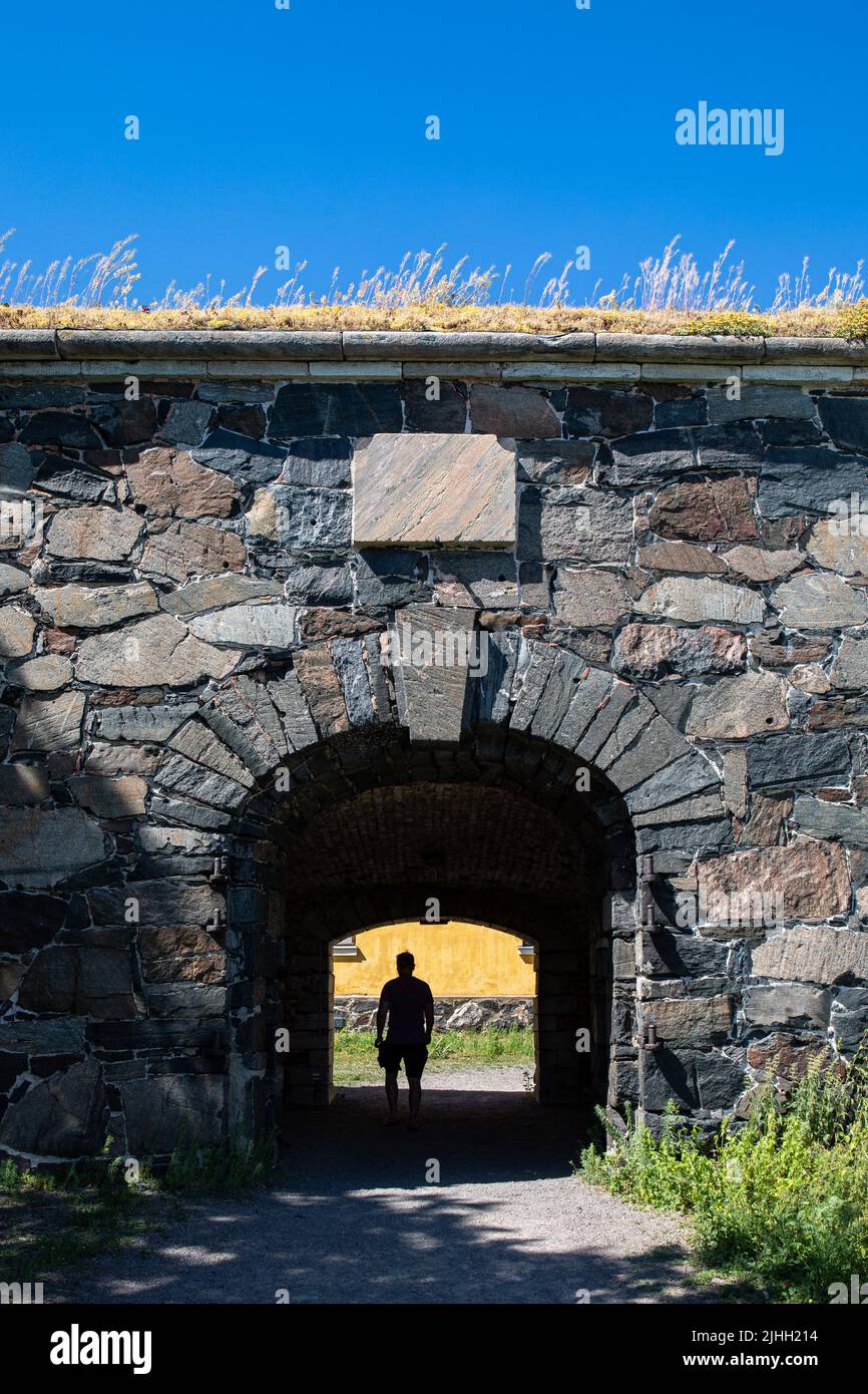 Man's silhouette in fortress gateway in Pikku Mustasaari Island of Suomenlinnna fortification, Helsinki, Finland Stock Photo