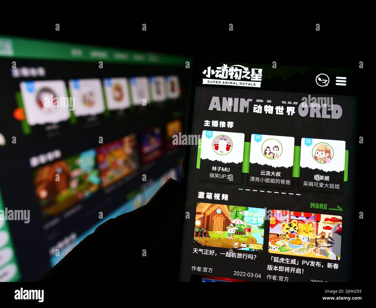 Person holding cellphone with webpage of gaming company iDreamSky Technology Holdings Ltd. on screen. Focus center of on phone display. Stock Photo