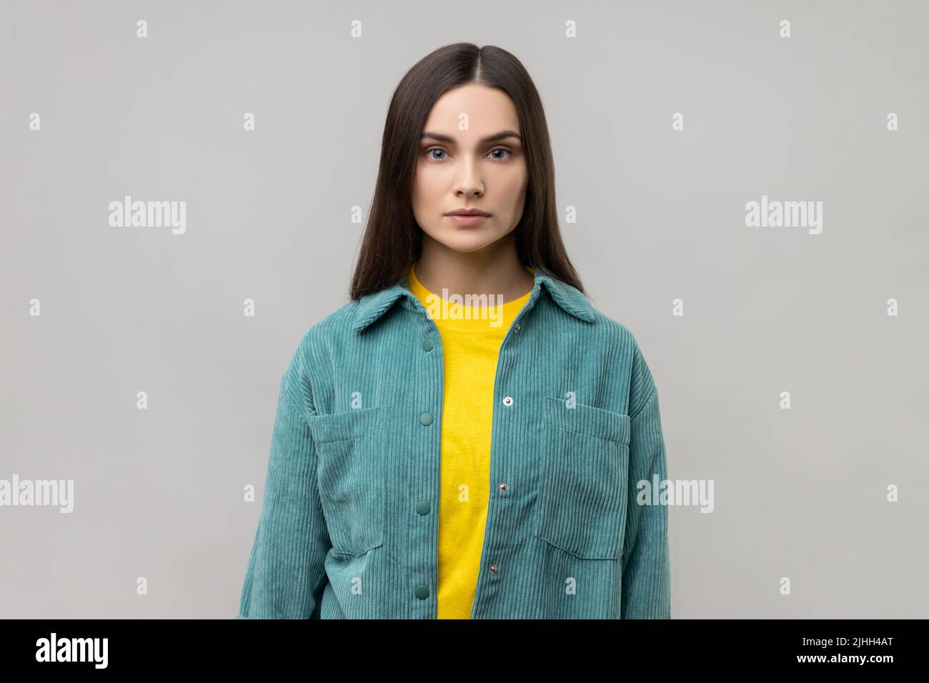 Portrait of strict bossy woman looking at camera, feels confident focused self-assured, expressing seriousness, wearing casual style jacket. Indoor studio shot isolated on gray background. Stock Photo