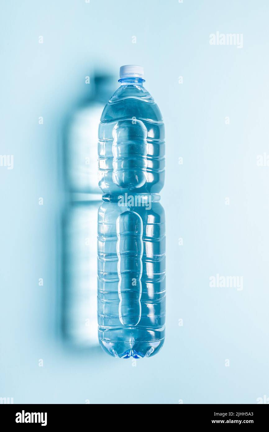 Plastic water bottle on blue background. Top view. Stock Photo