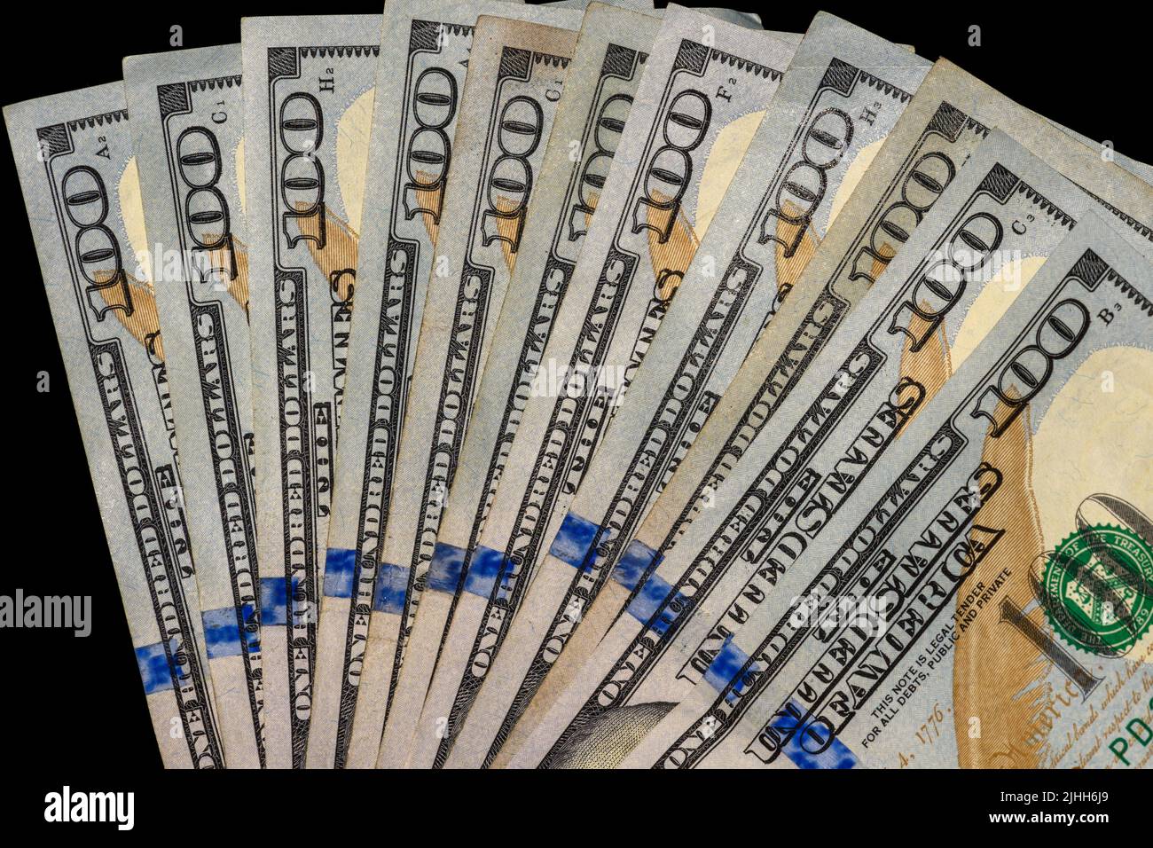 100 Dollar Bills fanned on black Background Stock Photo