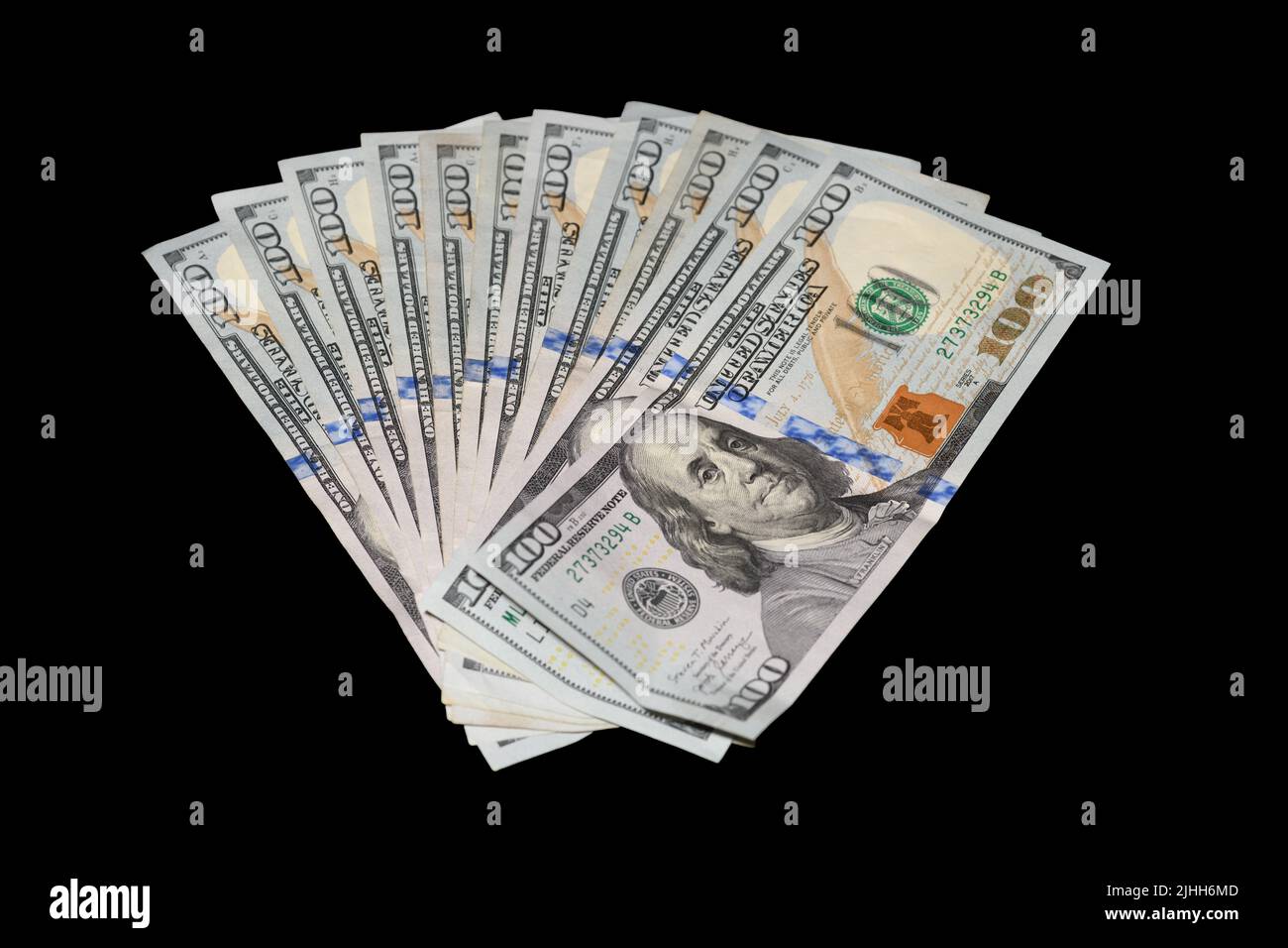 100 Dollar Bills Fanned on Black Background Stock Photo