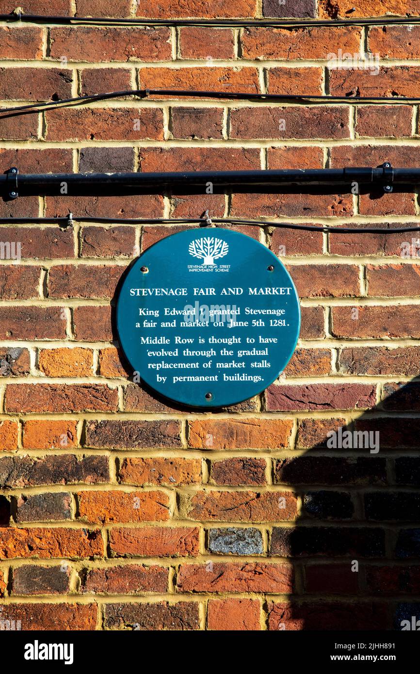 Green heritage plaque on Middle Row for Stevenage Fair and Market, Stevenage, Hertfordshire, UK Stock Photo