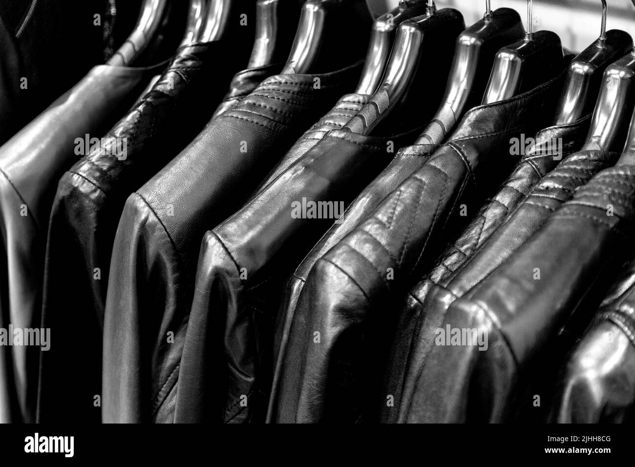 Colourful leather jackets in red and black hanging on a rail Stock Photo