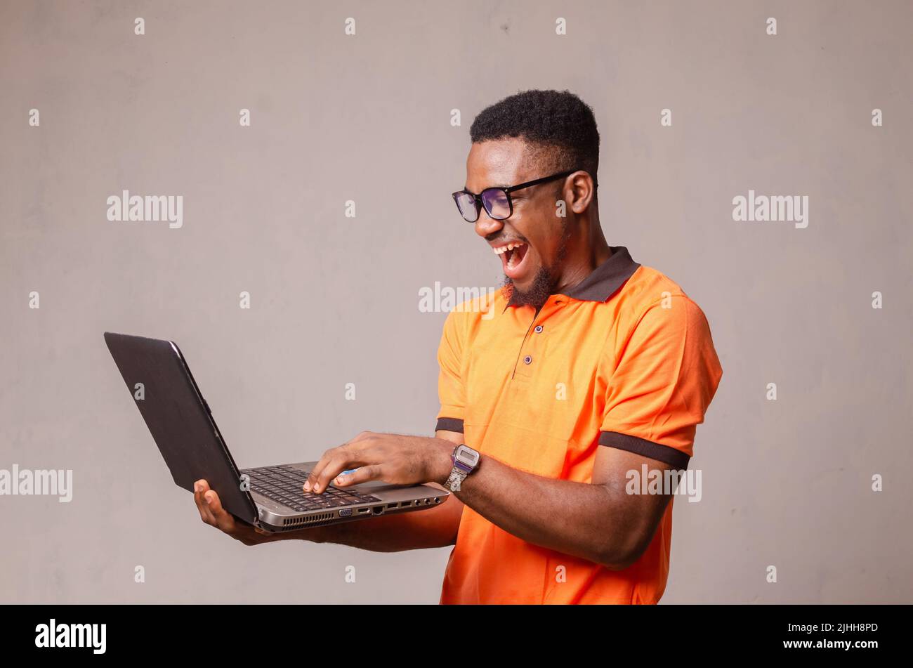excited boy isolated over white using his laptop Stock Photo