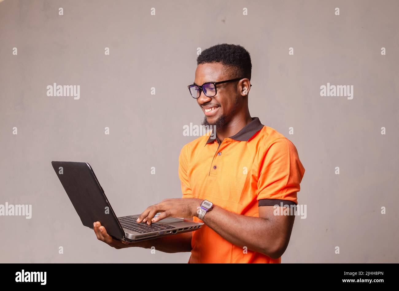 excited boy isolated over white using his laptop Stock Photo