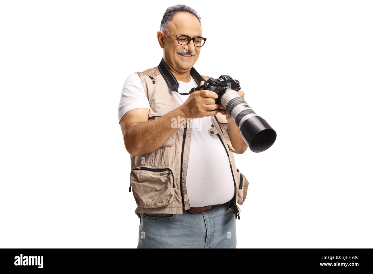 Male photo journalist holding a professional camera and checking an