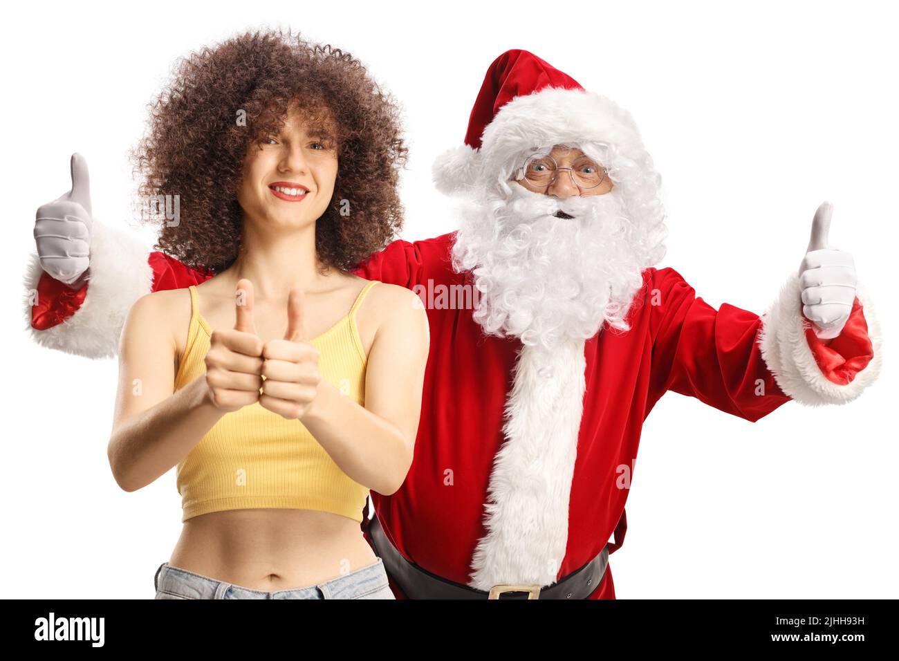 Young female and Santa claus gesturing thumbs up and smiling isolated on white background Stock Photo