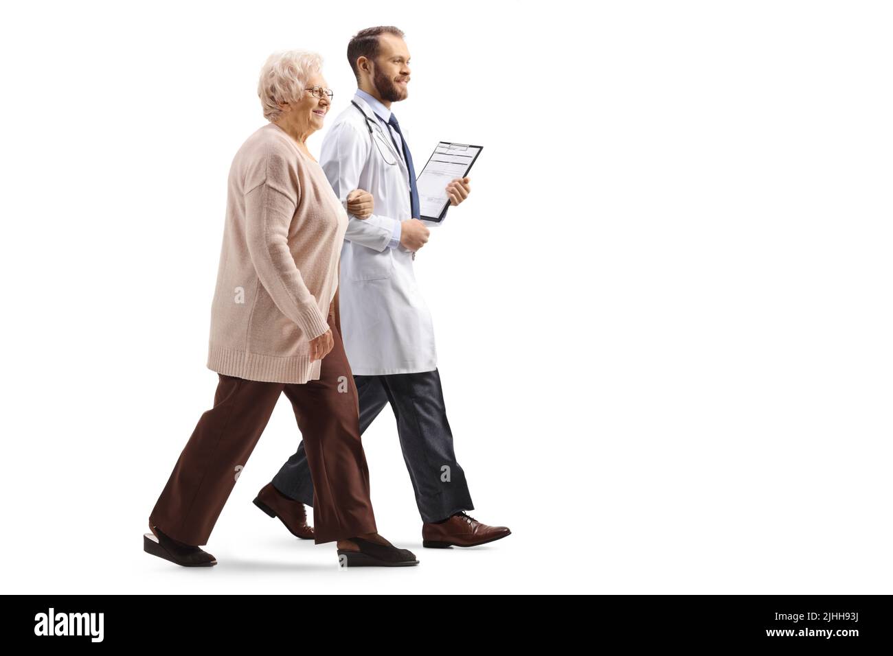 Full length profile shot of an elderly woman walking and holding a