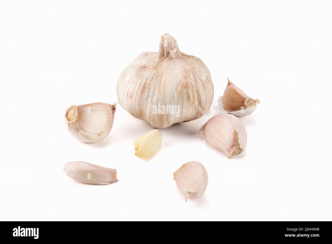Fresh garlic clove and bulb isolated on bright background Stock Photo ...