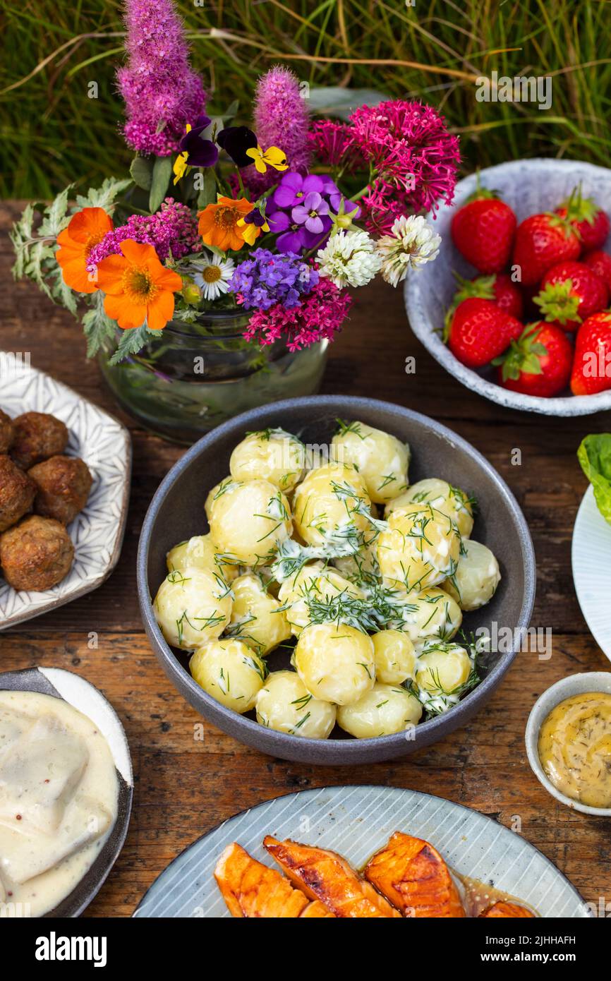 Scandinavian midsummer meal with  potato salad, salmon and eggs Stock Photo