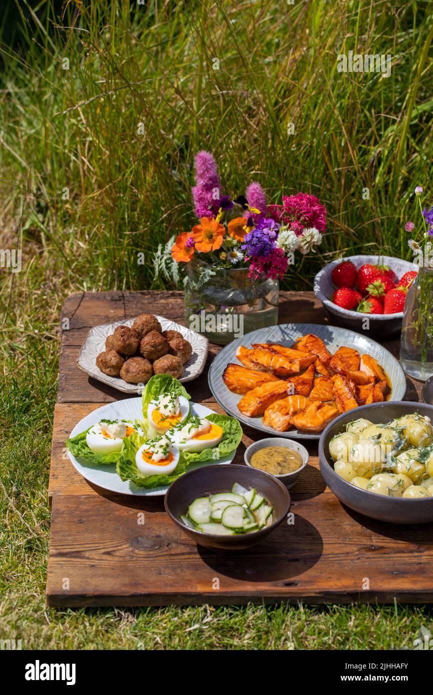 Scandinavian midsummer meal with  potato salad, salmon and eggs Stock Photo