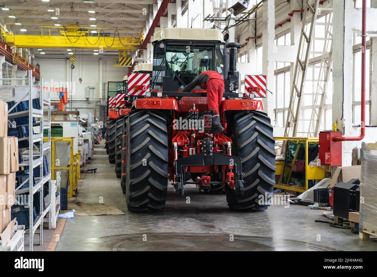 Large factory building interior inside. Production line of new modern agriculture machinery. Stock Photo