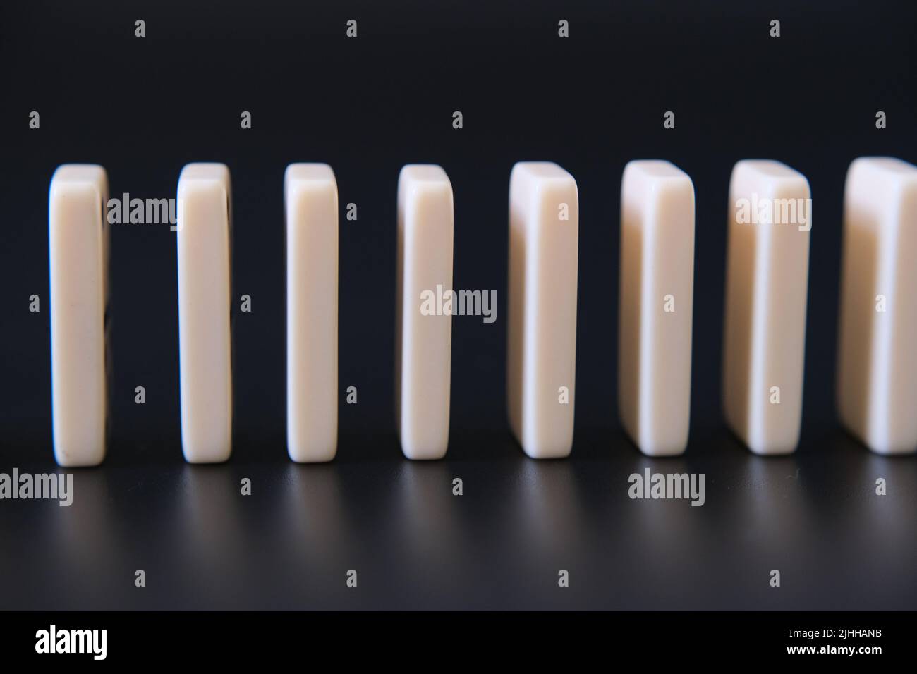 Domino effect. Conceptual photo. Dominos standing close to each other. Stock Photo
