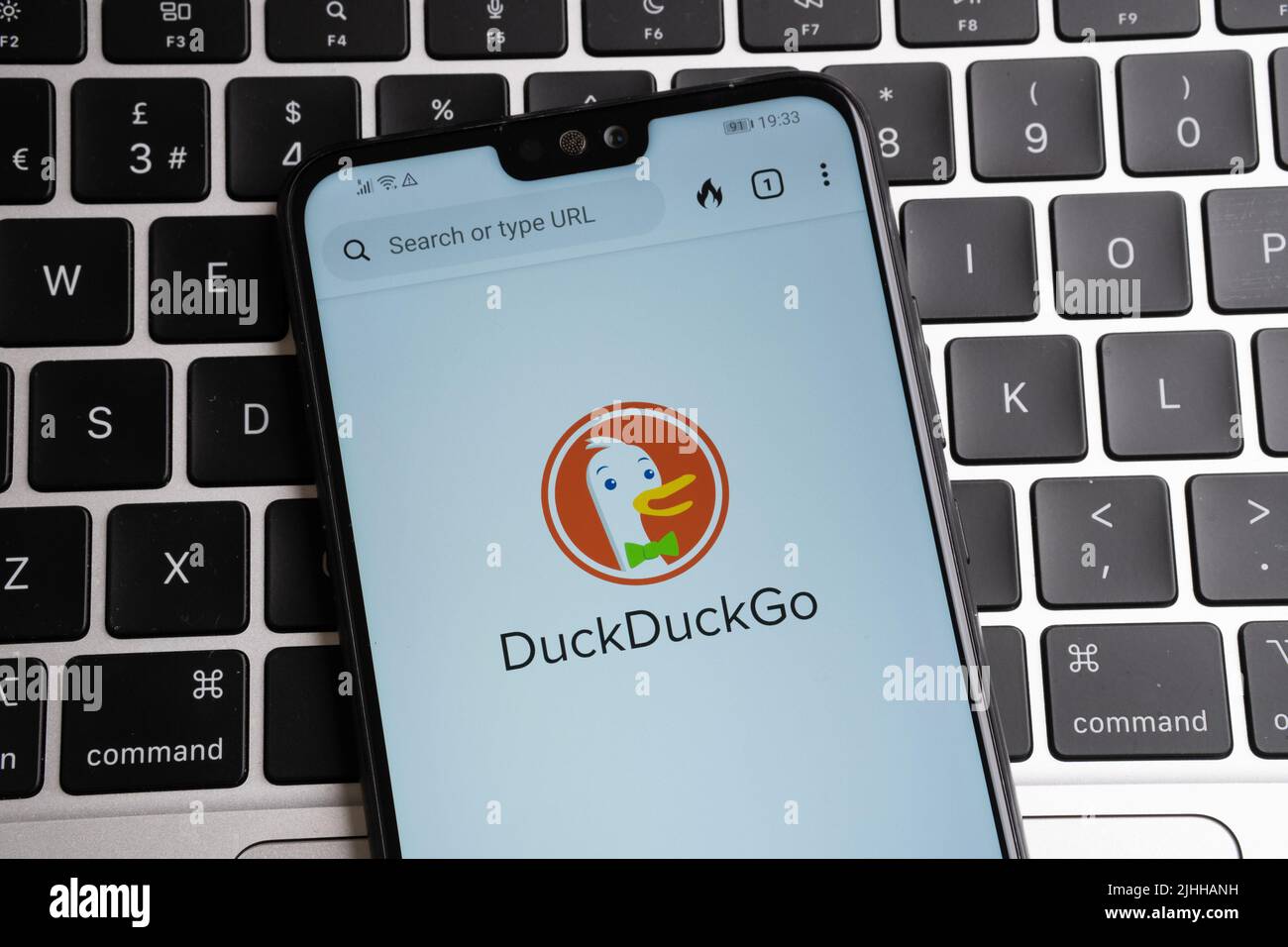 duckduckgo browser logo seen on smartphone placed on keyboard Stock