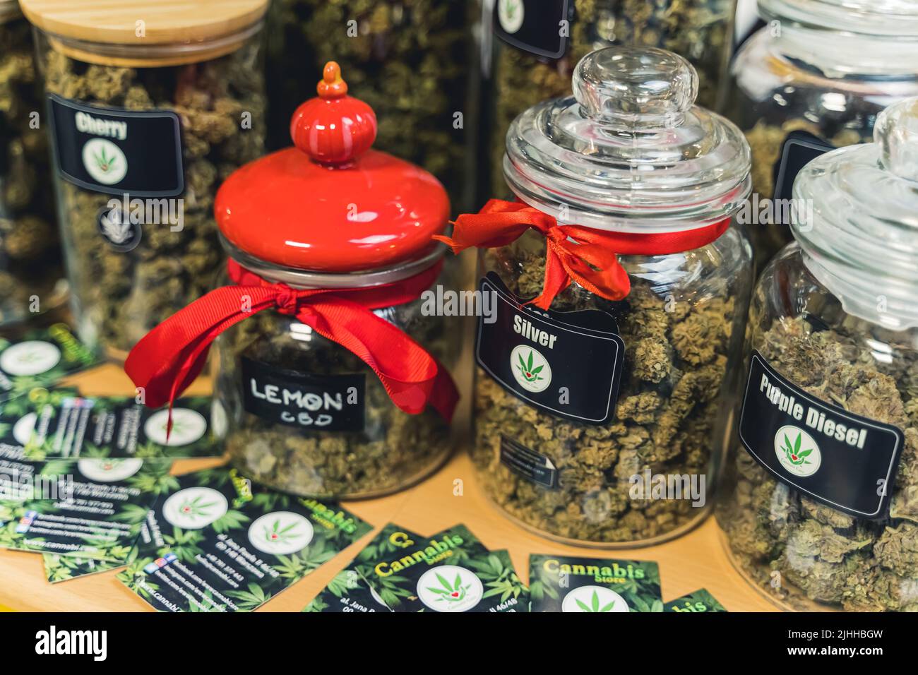 05.28.2022 Warsaw, Poland. Marijuana coffee shop. Big glass jars of legal CBD weed that helps with anxiety, stress, and pain relief. High quality photo Stock Photo