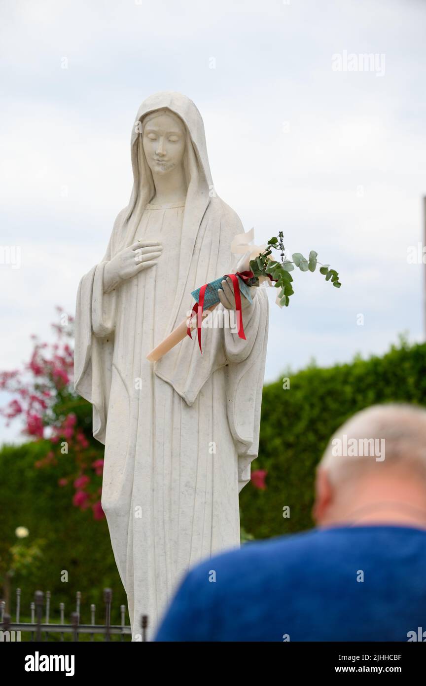 Statue of the Virgin Mary, the Queen of Peace, in front of the St James church in Medjugorje, Bosnia and Herzegovina. 2021-08-03. Stock Photo