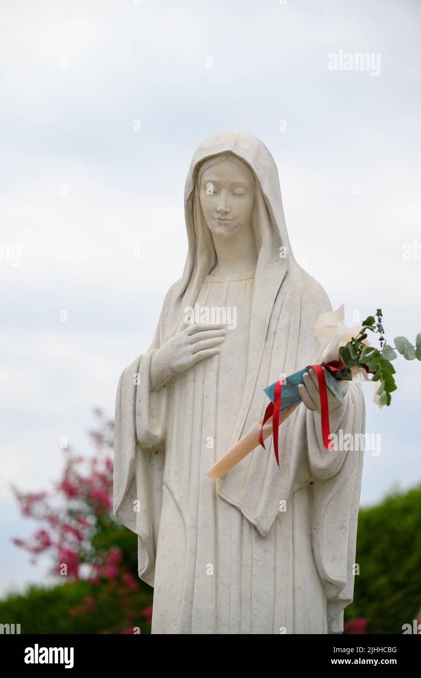 Statue of the Virgin Mary, the Queen of Peace, in front of the St James church in Medjugorje, Bosnia and Herzegovina. 2021-08-03. Stock Photo