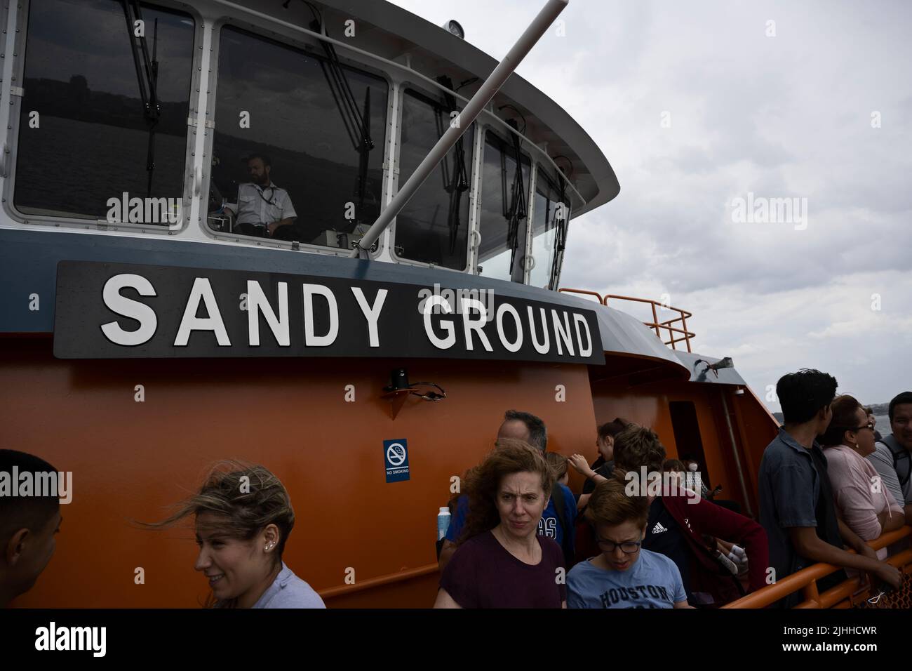 New York, US. 18 Jul 2022.  Passengers and pilot house of Sandy Ground Staten Island Ferry as it approaches Staten Island; NYC Department of Transportation annnounced reduced ferry schedule citing rise in COVID-19 cases; DOT says the modified schedule will be in effect through July 26.   New York City’s Health Department says 7-day average number of cases has doubled since April. Stock Photo