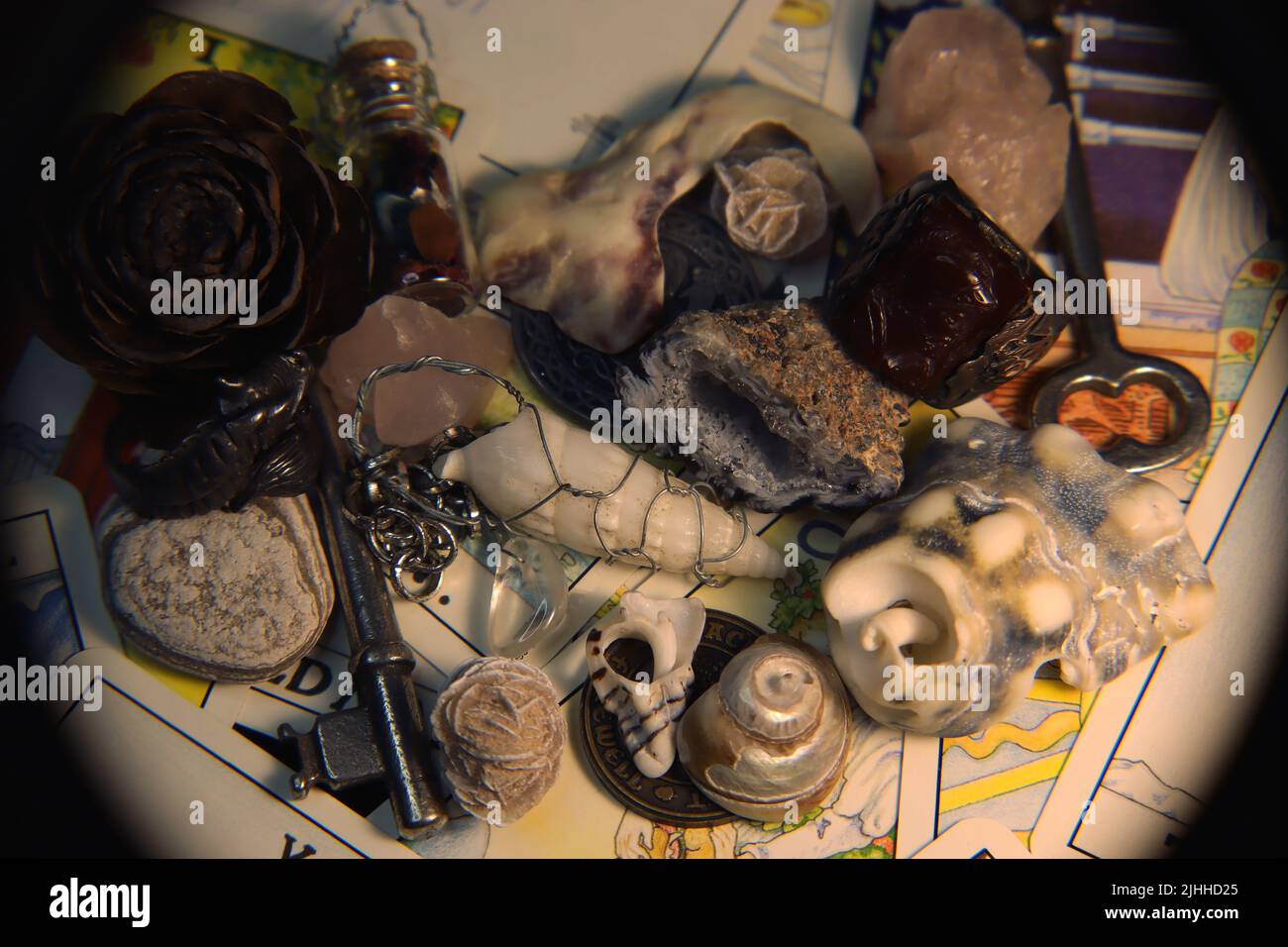 A collection of items likely found in someone's trinket box, or a goblin's pockets. Tarot card background. Stock Photo