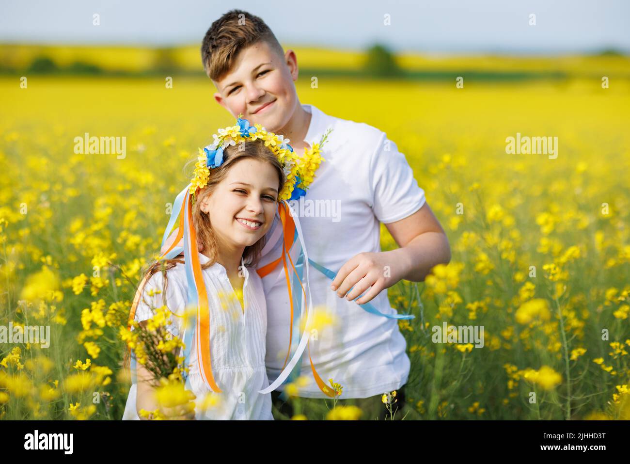 Front view of happy carefree native children: older teenage brother and ...