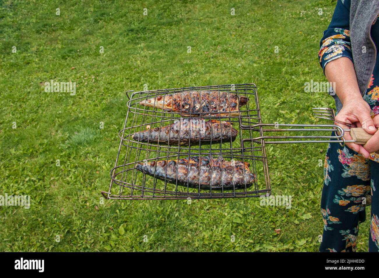 The process of cooking mackerel fish in a marinade on the grill. Fried ...