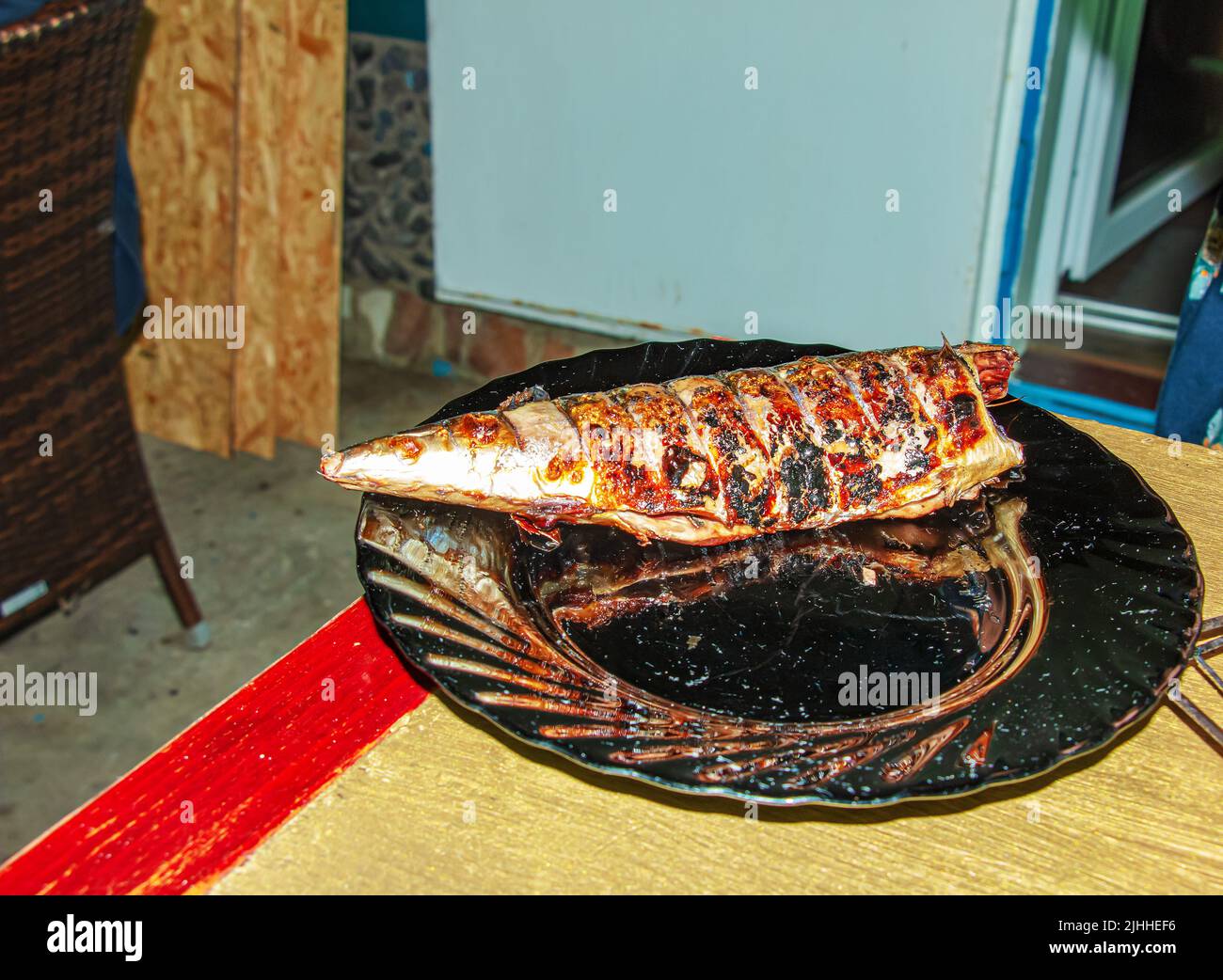 The process of cooking mackerel fish in a marinade on the grill. Fried ...