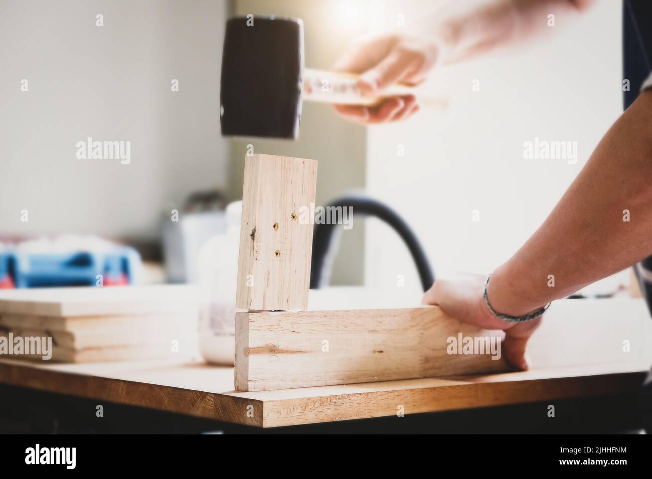 Focus on the woodwork, Entrepreneur Woodwork holding hammer to assemble the wood pieces as the customer ordered Stock Photo