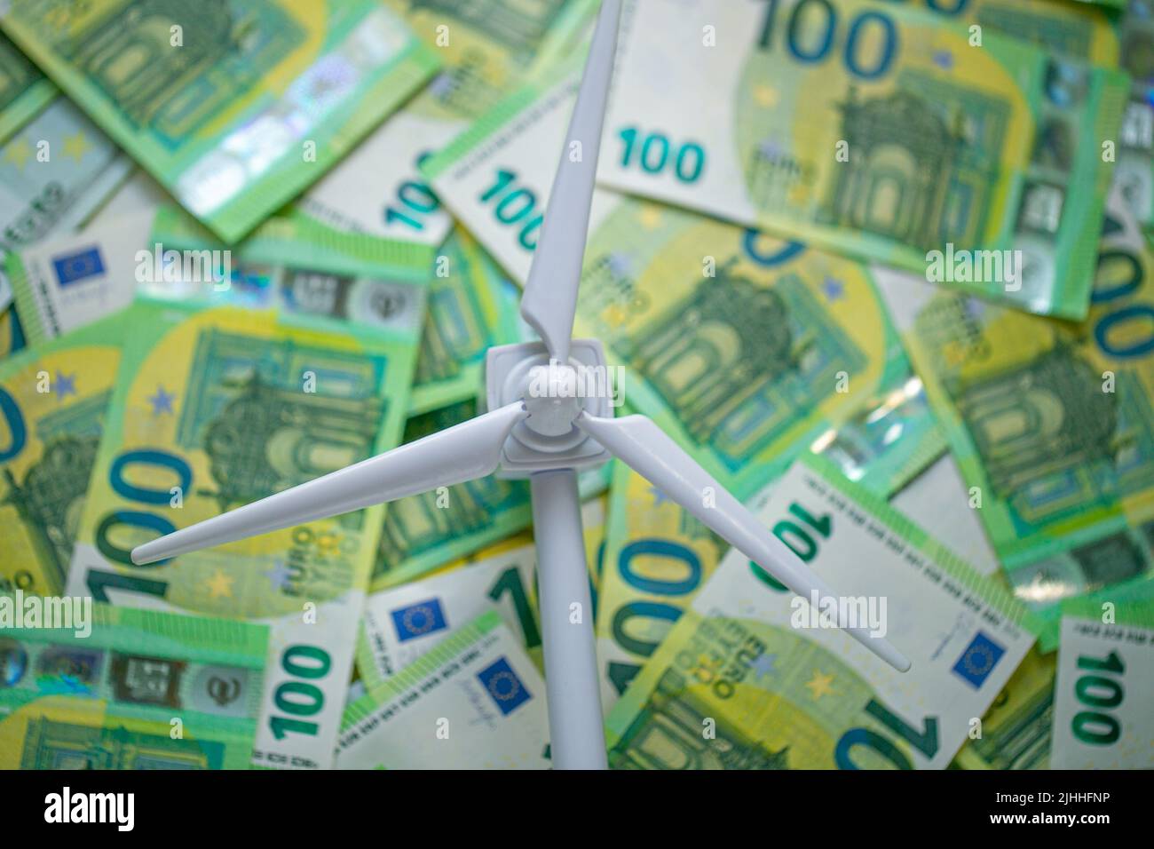 Wind energy price.Green renewable energy cost. Payment for wind energy. cost of green renewable energy. white wind generator on euro bills background Stock Photo