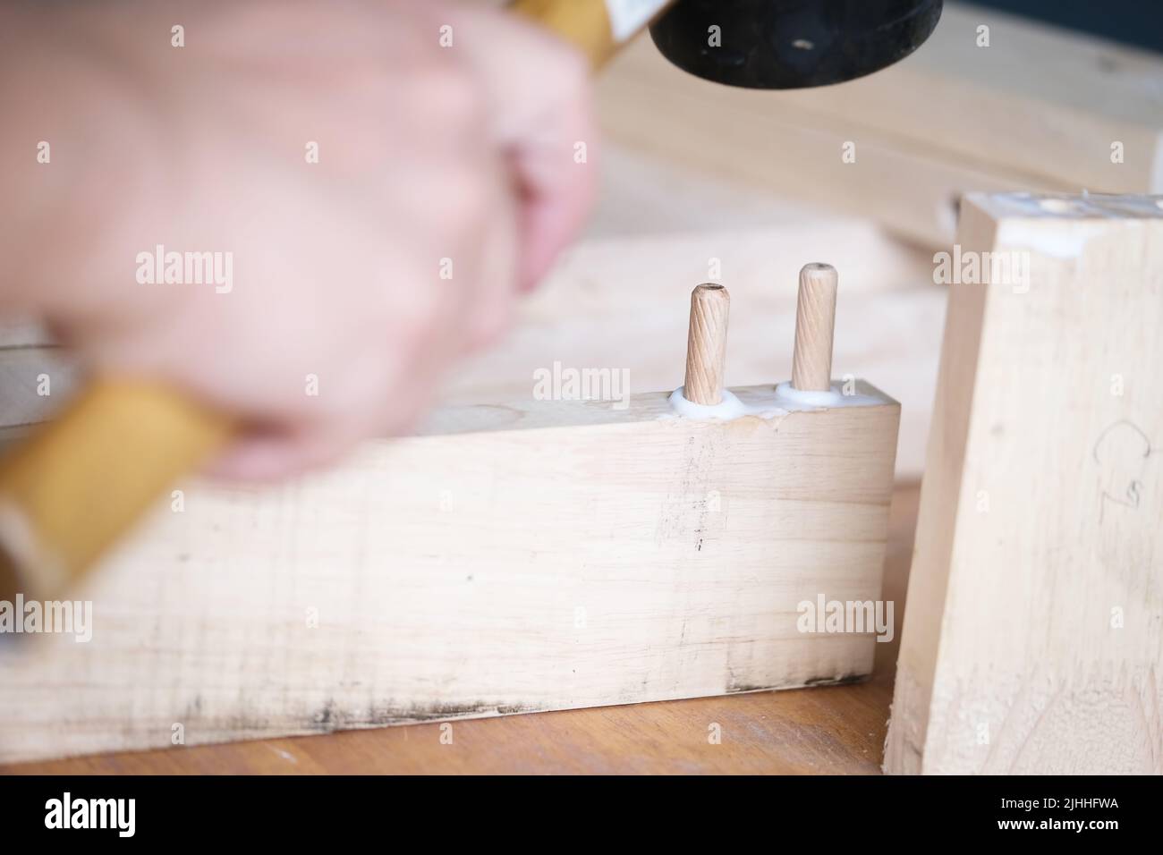 Focus on the woodwork, Entrepreneur Woodwork holding hammer to assemble the wood pieces as the customer ordered Stock Photo
