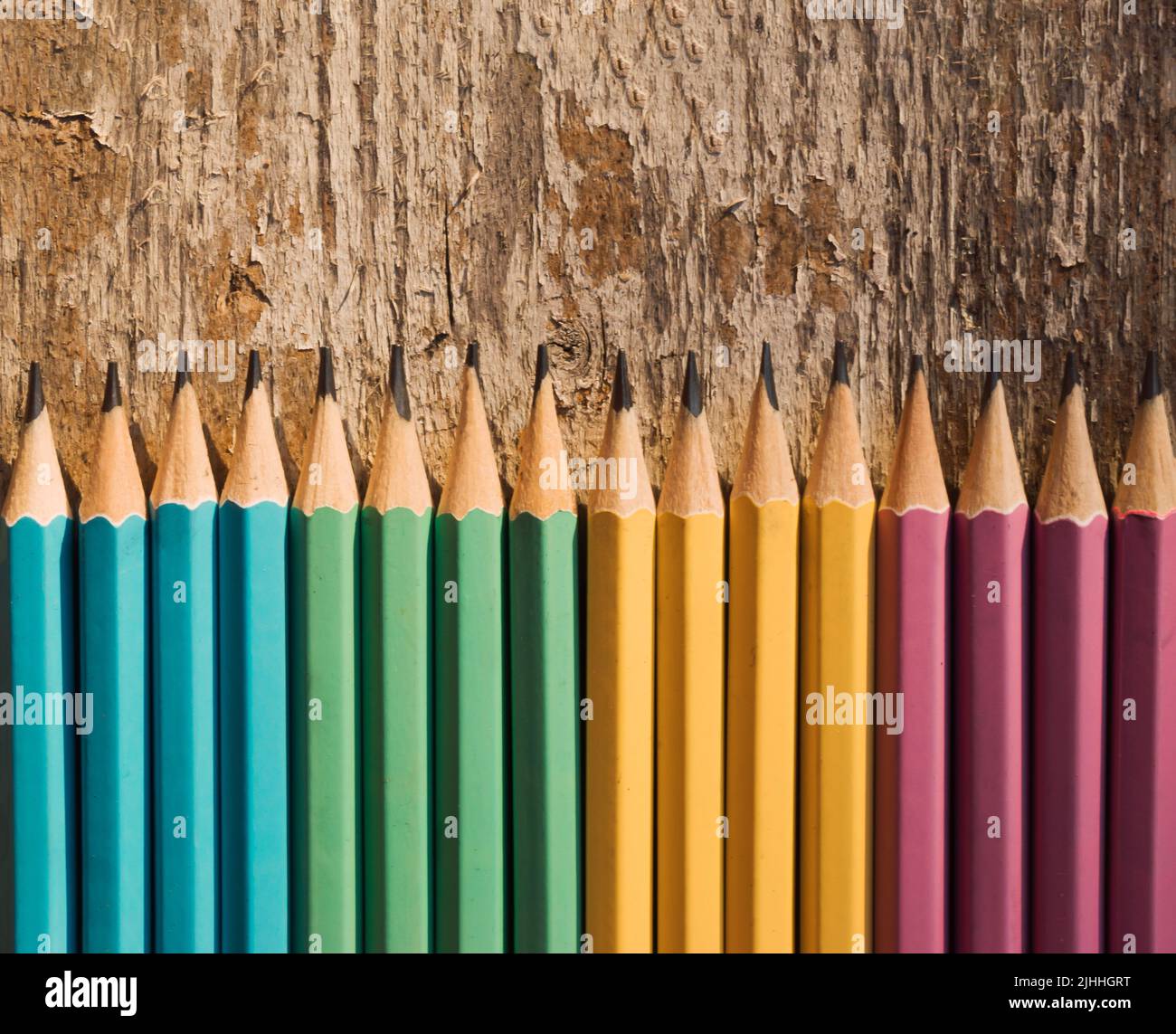 Colored pencils on wooden background. Top view with copy space. Flat lay. Back to school, education concept. Stock Photo