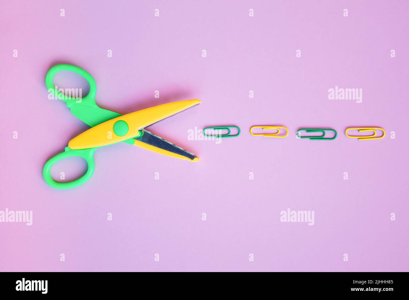 Back to school concept with school supplies, scissors, paper clips on pastel purple background. Top view with copy space. Flat lay. Stock Photo