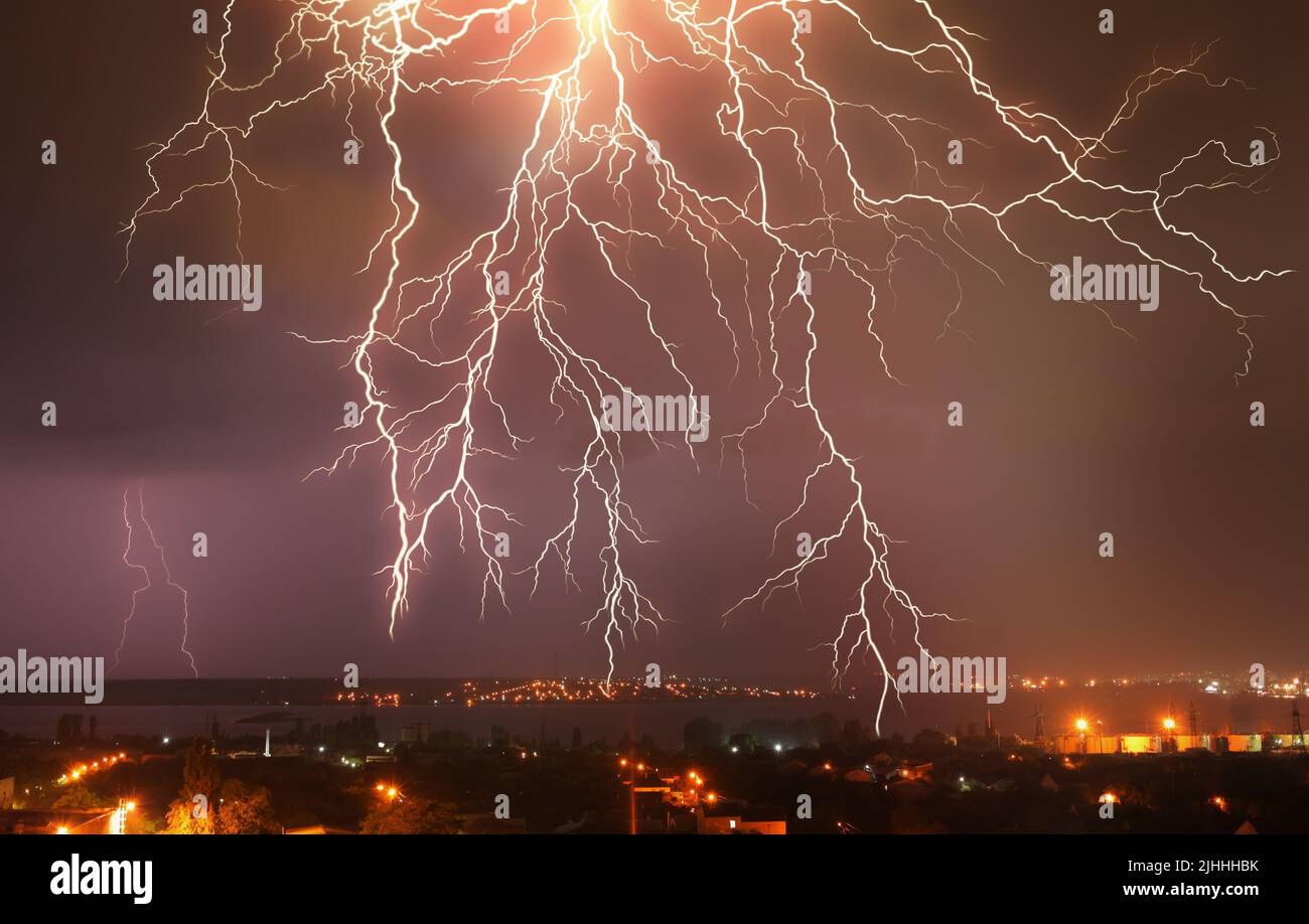Lightning in dark sky over the city at night Stock Photo - Alamy