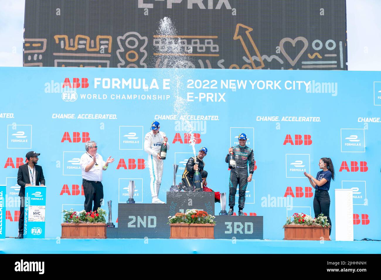 NEW YORK, NY - JULY 17: First place winner Antonio Felix Da Costa (C) (car no. 13) of DS Techeetah, who secured his first win of the season, along with second place new championship leader Stoffel Vandoorne (L) (Car no. 5) of Mercedes EQ and third place Mitch Evans (R) (car no. 9) of Jaguar TCS Racing celebrate on the podium with champagne during the ABB FIA Formula E Championship, New York City E-Prix Season 8 Round 12, on July 17, 2022 in the Brooklyn borough of New York City. Stock Photo