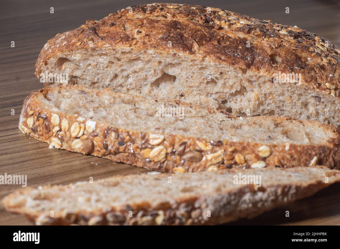 Whole wheat rye bread slice with seeds, multigrain bread on a wooden
