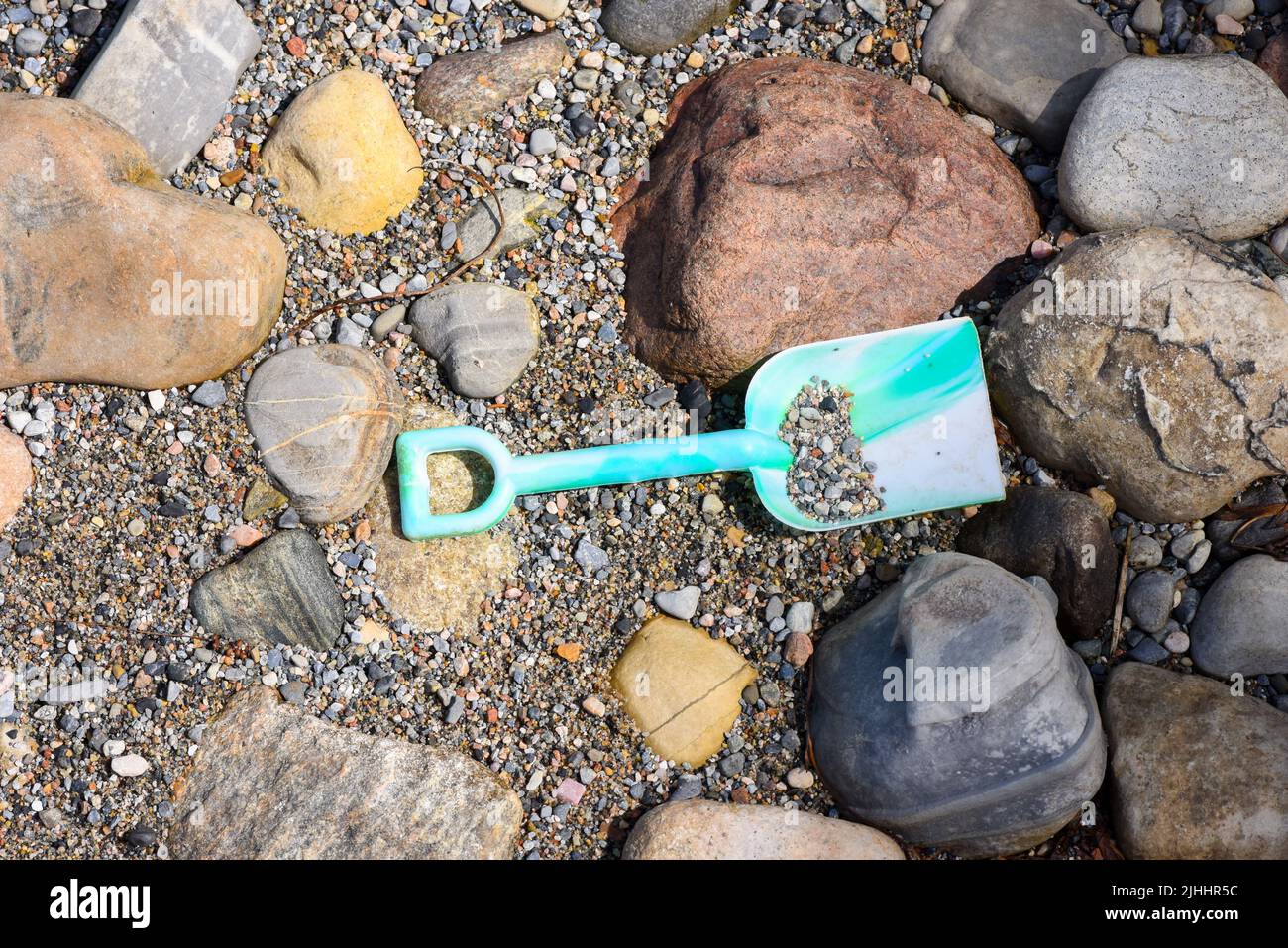 Child's plastic shovel on a beach Stock Photo