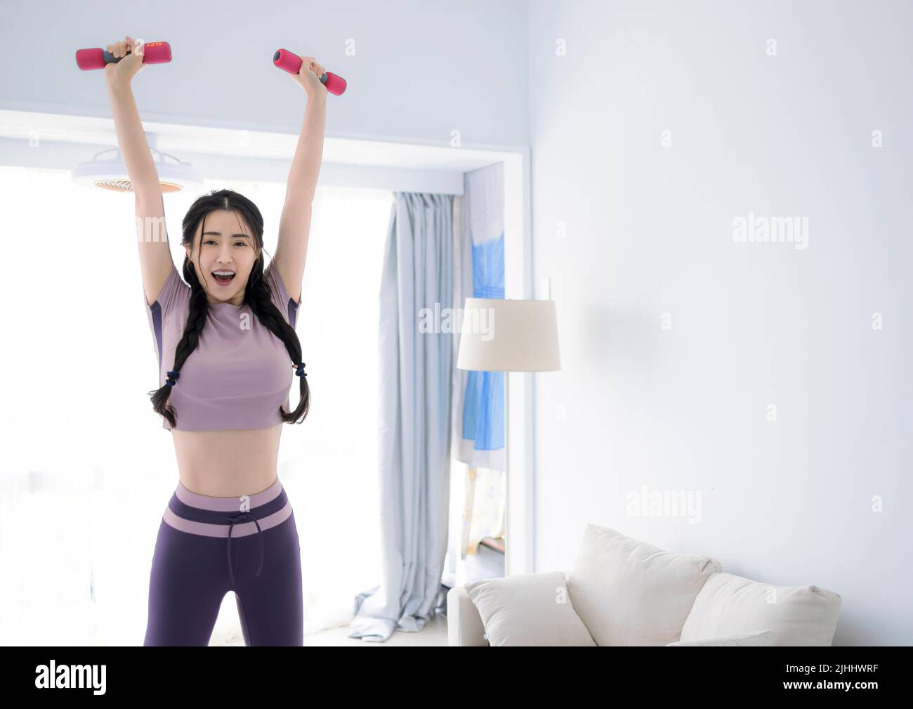 Young Asian healthy woman workout at home, home fitness concept Stock Photo