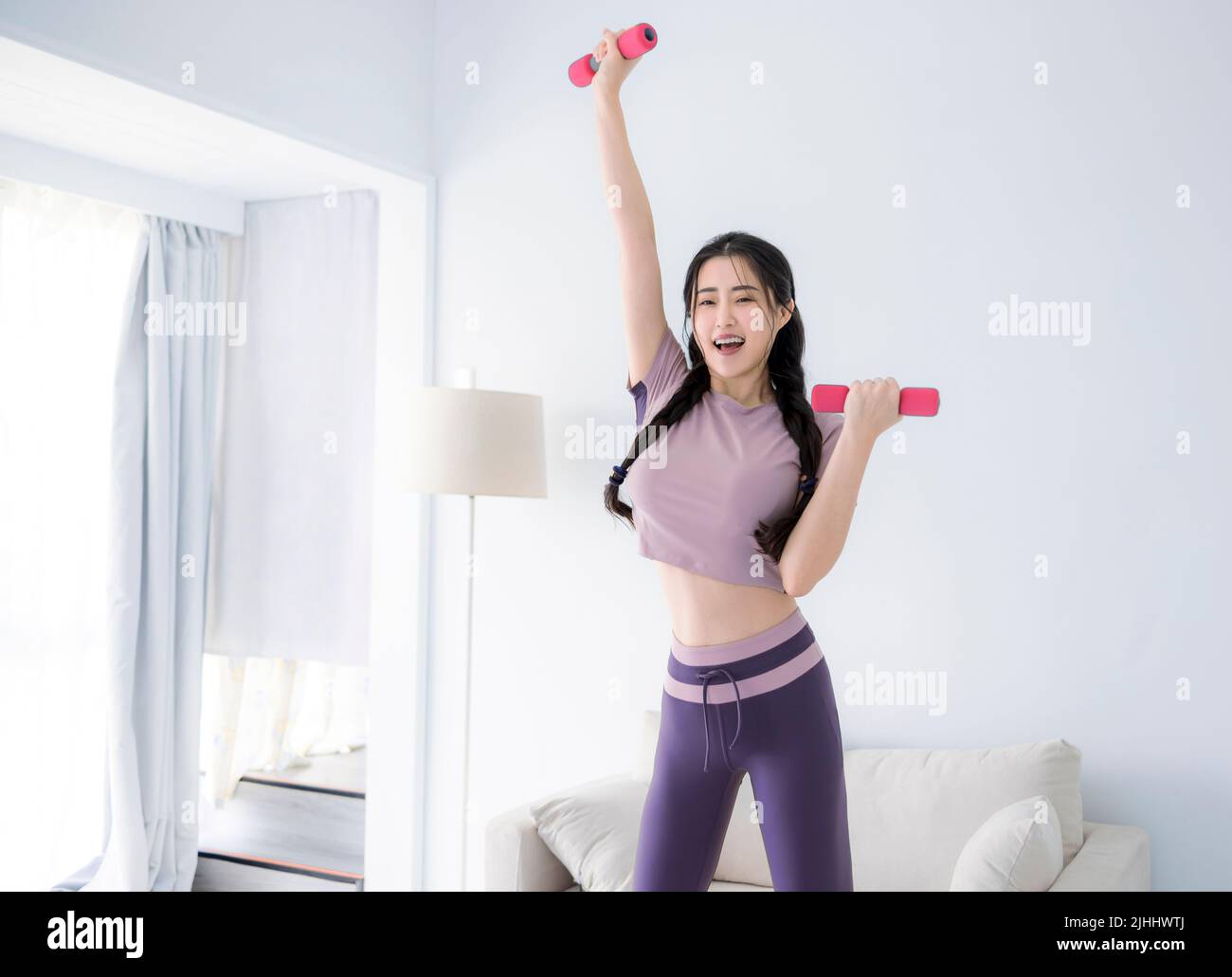 Young Asian healthy woman workout at home, home fitness concept Stock Photo