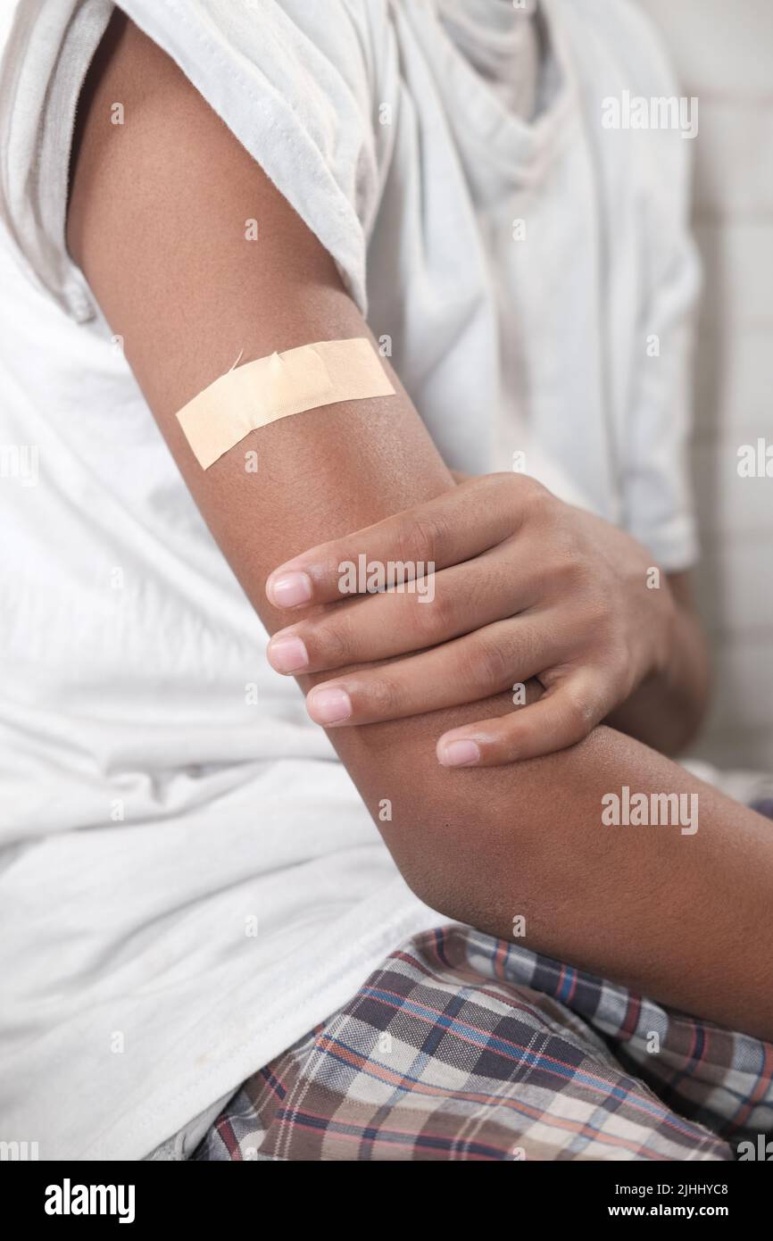 adhesive bandage on young man's arm  Stock Photo