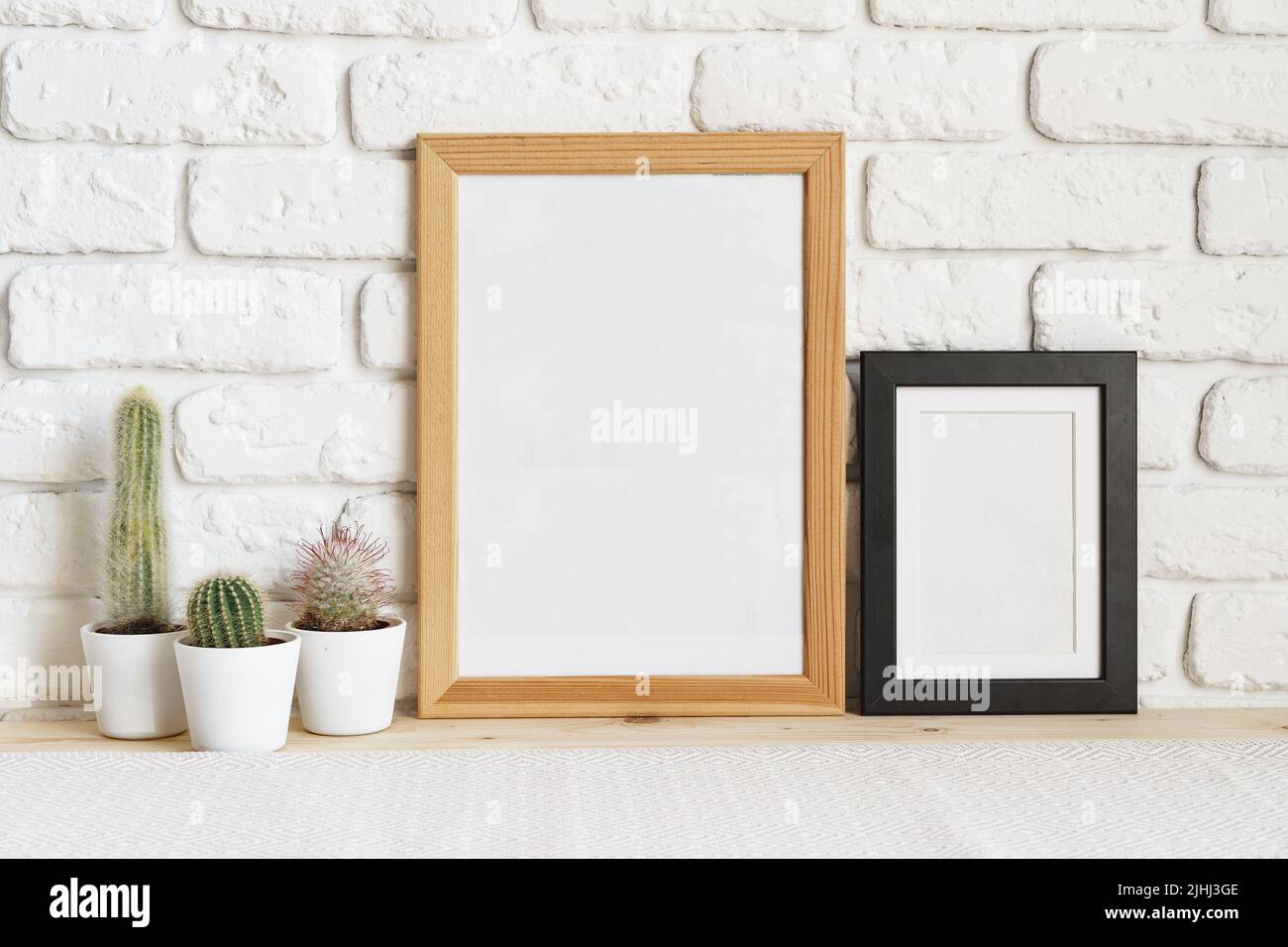 Square wooden photo frame and cactus plants on the table Stock Photo ...