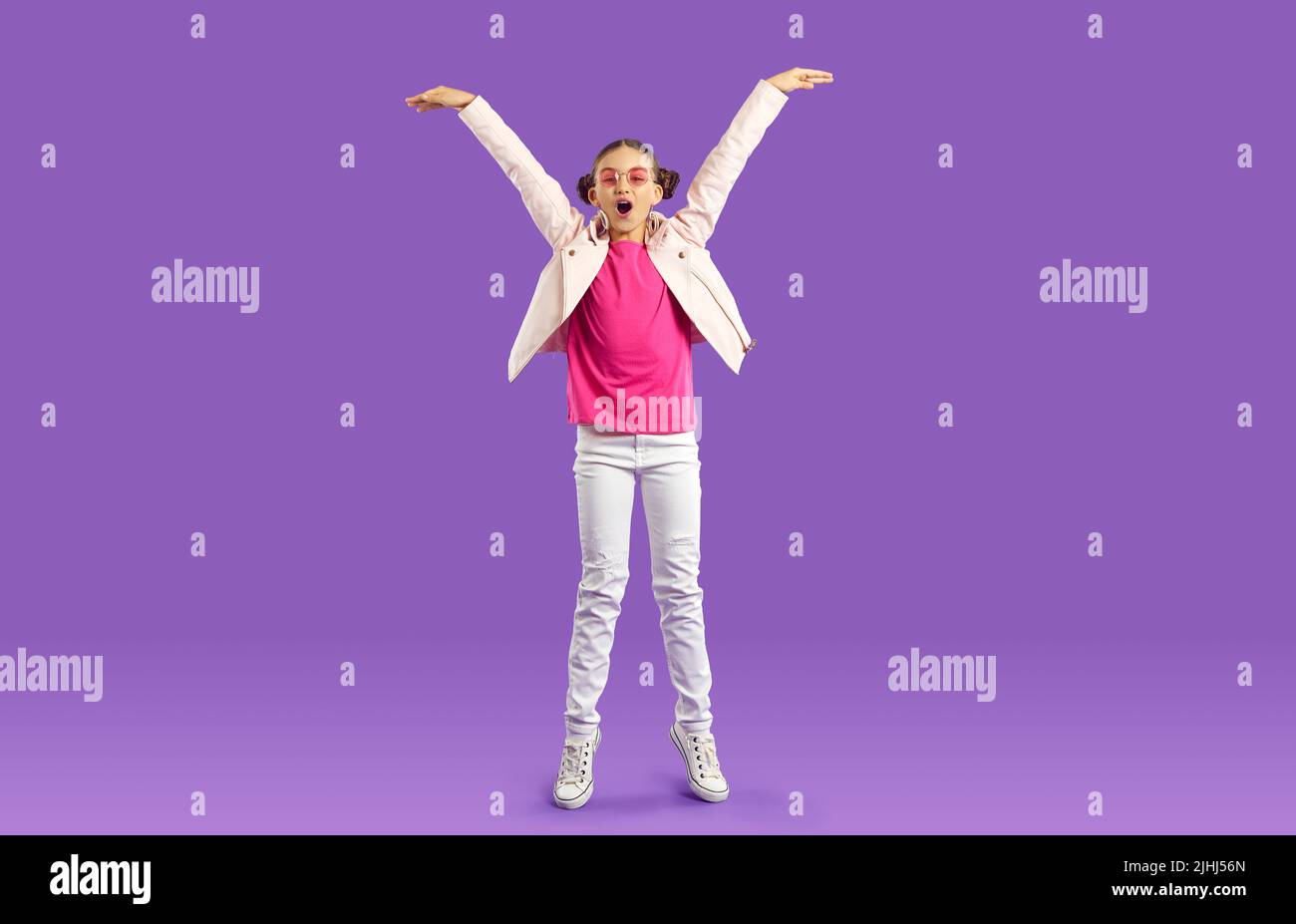 Overjoyed teen girl show height Stock Photo