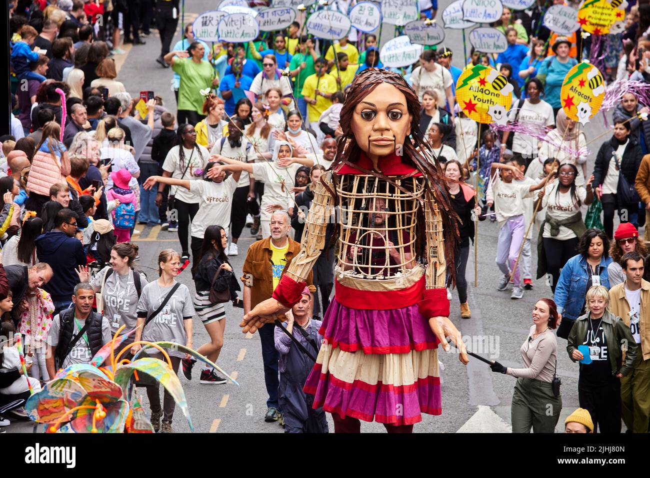 Manchester Day parade 2022 in Manchester city centre world famous Little Amal refugee puppet happens across the festival and joins the walk Stock Photo
